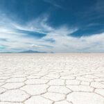 dry soil under white clouds and blue sky at daytime